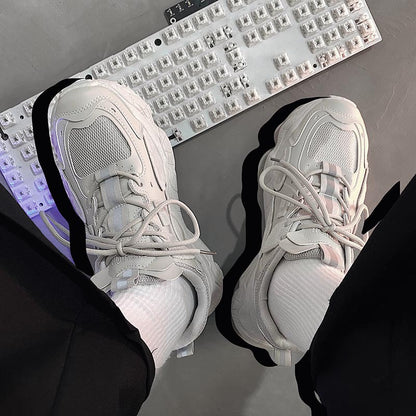 White sneakers on a desk with a keyboard in the background