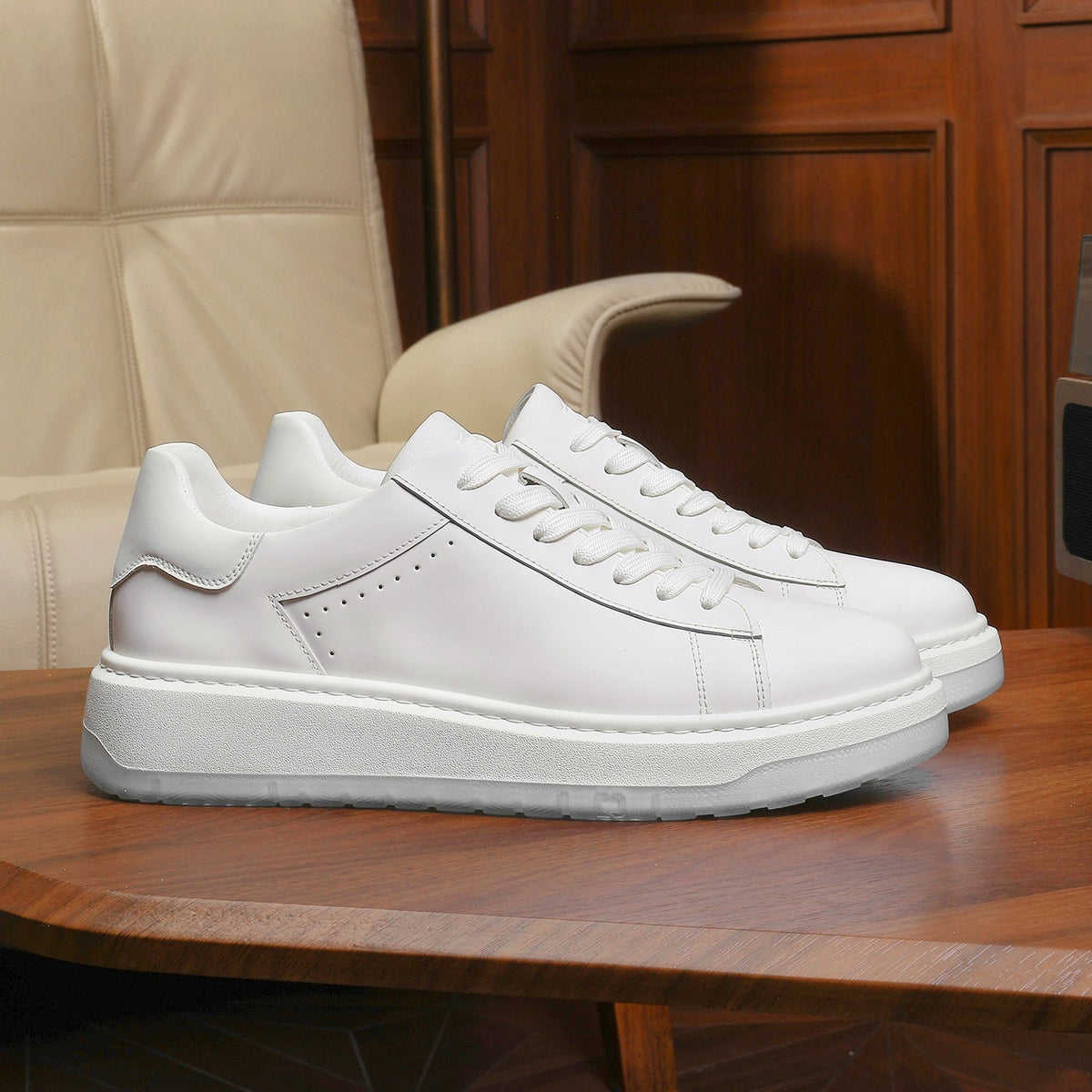 White sneakers on a wooden table with a beige chair and wooden panel background