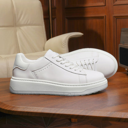 White sneakers on a wooden table with a beige chair in the background