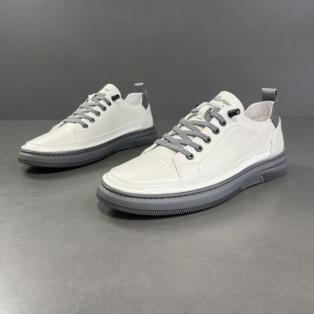White sneakers with gray laces on a gray background