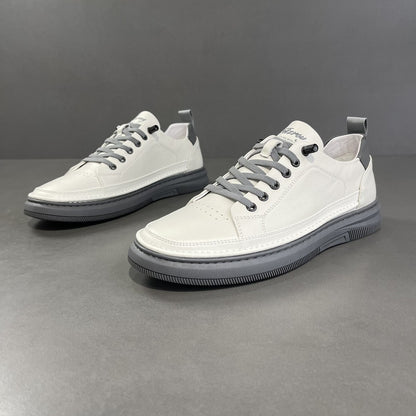 White sneakers with gray laces on a gray background