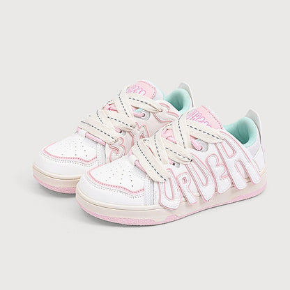 White sneakers with pink accents and 'Superga' branding on a light gray background
